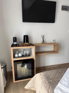 a tv on a wall with a small oven at ThasosGoldenStay in Skala Potamias
