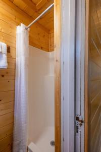 a bathroom with a shower with a shower curtain at Union Creek Resort in Union Creek +90 photos