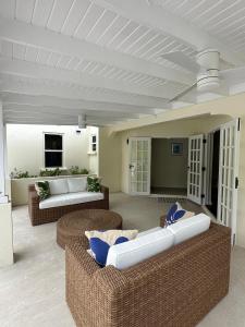 a living room with two couches and a table at Casa Colibri in Saint James +16 photos