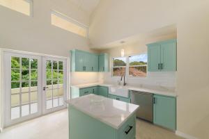 a kitchen with blue cabinets and a white counter top at Casa Colibri in Saint James