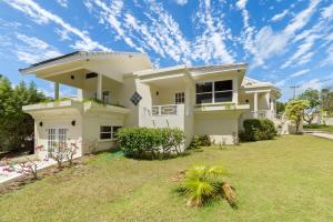 a large white house with a large yard at Casa Colibri in Saint James