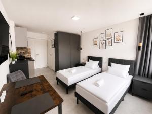 a living room with two beds and a coffee table at Lipp Apartments in Cologne