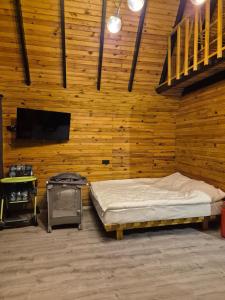 a room with a bed and a stove in it at Yonga Bungalov in Akcaabat