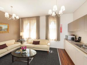 a living room with a couch and a table at Adabco Boutique Hotel Adelaide in Adelaide
