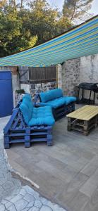 a group of blue pillows sitting on a patio at cosy studio in Saint-Maximin-la-Sainte-Baume