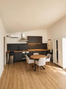 a kitchen and dining room with a table and chairs at DEIVID house for rent in Skulte +16 photos