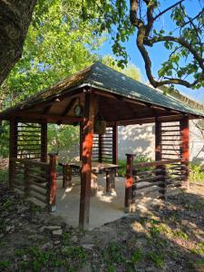 a wooden pavilion with a bench in a park at SaDa Riverside in Apatin +24 photos