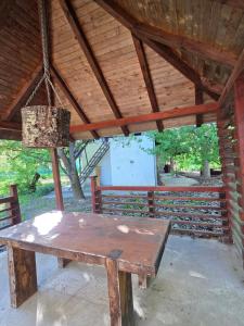 a wooden picnic table in a pavilion with a light at SaDa Riverside in Apatin