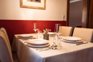 a table with plates and wine glasses on it at Ferienwohnung Kreidl in Schlitters +30 photos