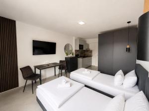 a living room with two beds and a table at Lipp Apartments in Cologne
