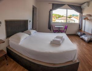 a bedroom with a large bed with towels on it at GarçaView in Vila Franca do Campo
