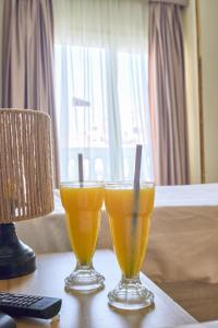 two glasses of orange juice sitting on a table at Star View Pyramids Hostel in Nazlet el-Sîsi