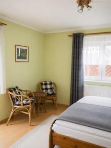 a bedroom with a bed and a table and chairs at Pension NoAs in Sassnitz
