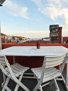 a white table and two chairs on a roof at Hvar old Town Boutique in Hvar