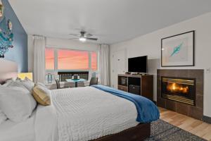 a bedroom with a bed and a fireplace at Sunset Haven Oceanfront Hotel in Depoe Bay