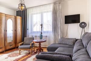 a living room with a couch and a table at Willa Antonina in Supraśl