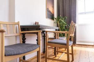 a dining room with two chairs and a table at Willa Antonina in Supraśl