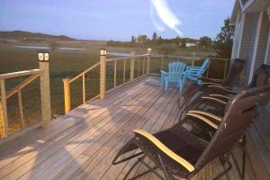 a deck with chairs and a table on a house at Seascape Serenity with Epic Coastal Views! in Lubec