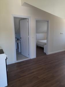 an empty room with a bed and a mirror at Holiday Apartment in Draç