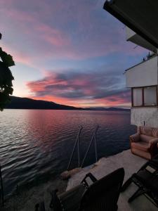 a view of a body of water with chairs at villa stavri in Pogradec +22 photos