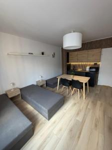 a living room with a bed and a table at Apartament Tczew-duże pokoje! in Tczew