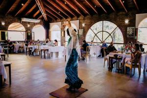 a woman in a dress is dancing in a room at La Posada Del Qenti - All Inclusive Saludable in Villa Carlos Paz