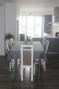 a dining room table and chairs in a kitchen at Casa do Tempo in Achada +29 photos