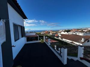 a balcony of a house with a view of the ocean at Casa do Tempo in Achada