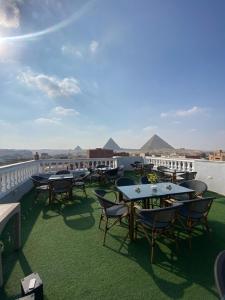 a row of tables and chairs on a balcony at Star View Pyramids Hostel in Nazlet el-Sîsi
