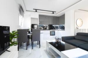 a kitchen and living room with a table and a couch at Newly built detached house with parking 2 in Larisa