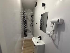 a white bathroom with a sink and a shower at Apartament Tczew-duże pokoje! in Tczew +42 photos