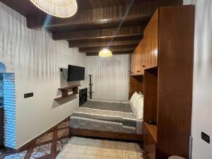 a bedroom with a bed and a tv in it at Studio ALADIN in Rabat +2 photos