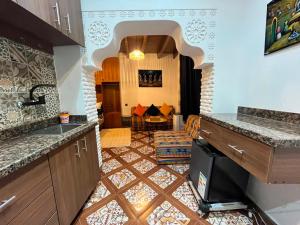 a kitchen with a sink and a counter top at Studio ALADIN in Rabat