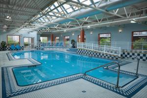 a large indoor swimming pool with blue water at Hotel Halifax in Halifax