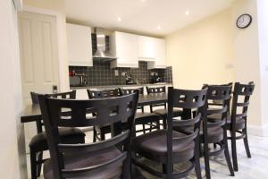 a dining room with a table and chairs in a kitchen at Townlets Townhouse in Belfast