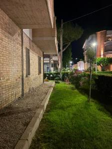 a brick building with a grass yard at night at Casa Rosa Anna in Martinsicuro
