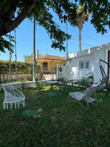 a yard with chairs and a table and a house at B&B Aura in Pontecagnano