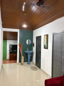 a bathroom with a blue sink in a room at Koyiloth house by intertrip in Kalpetta