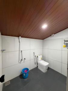 a bathroom with a toilet and a shower at Koyiloth house by intertrip in Kalpetta +18 photos