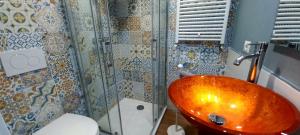 a bathroom with a copper sink and a shower at Il Falcineto in Pesaro