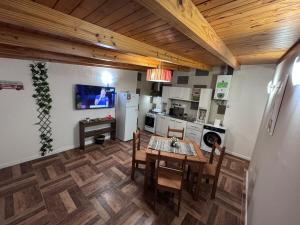 a kitchen with a dining room table and a refrigerator at Hermoso Departamento - Centro in Río Grande