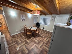 a dining room with a table and chairs on a wooden floor at Hermoso Departamento - Centro in Río Grande