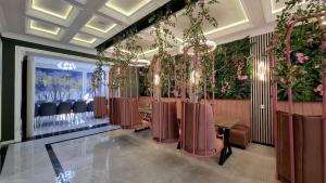 a row of chairs in a room with flowers at ZemZemHotel in Zaqatala