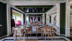 a dining room with wooden tables and chairs at ZemZemHotel in Zaqatala