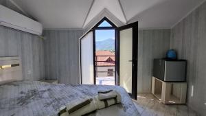 a bedroom with a large bed and a large window at ZemZemHotel in Zaqatala +28 photos