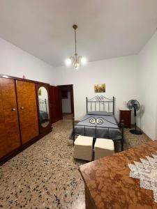 a bedroom with a bed and a table and chairs at Casa Rosa Anna in Martinsicuro