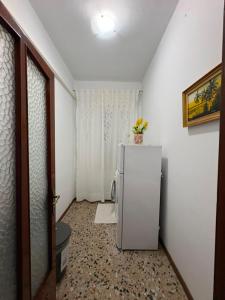 a white refrigerator in a room with a hallway at Casa Rosa Anna in Martinsicuro