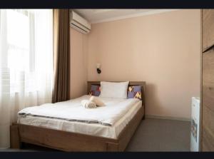 a bedroom with a bed with a stuffed animal on it at Tem Hotel in Khorog
