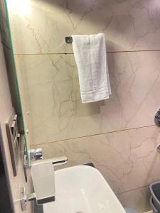 a bathroom with a white sink and a white towel at Vakil Villa in Srinagar +31 photos