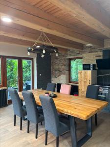 a dining room with a wooden table and chairs at Kuća za odmor - Villa Magdalena in Otočac